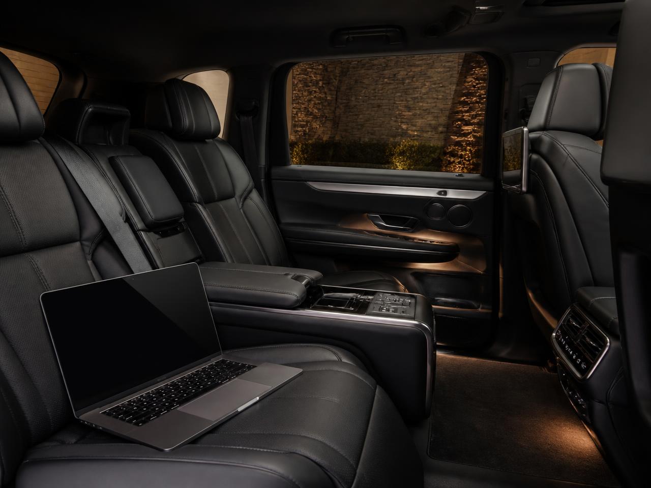 Rear cabin of a JRB Limousine executive SUV with black leather seating